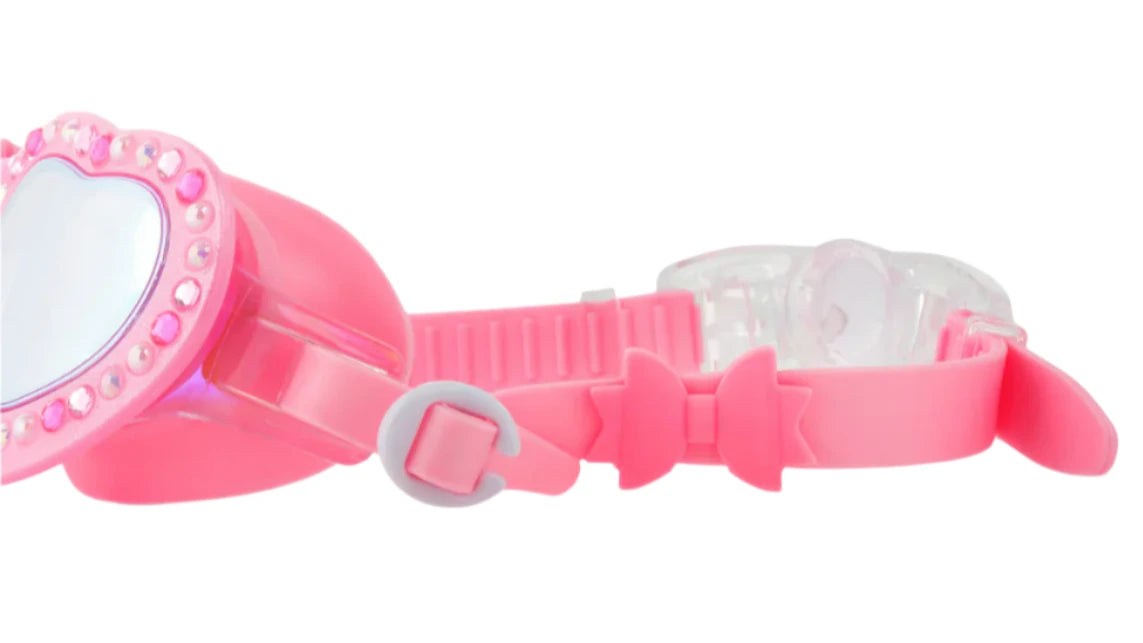 Close-up of Bling2O Beautiful Bows Swim Goggles with a heart-shaped frame, sparkling rhinestones, and a cute pink bow slider accent on the strap.