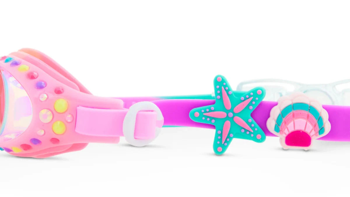 Close-up of Bling2O Tropical Rhinestone Swim Goggles for kids, featuring decorative starfish and seashell designs on the strap with sparkling rhinestones and fun beach-themed sliders.