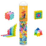 A clear tube of Plus-Plus Tube - 240 Piece Tropical Mix building blocks by Plus Plus, featuring colorful shapes like cubes, stairs, squares, and rings. A fun STEM toy that sparks creativity and develops fine motor skills.