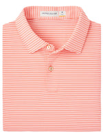 The Featherweight Payne Stripe Polo by Peter Millar is a folded orange and white striped polo shirt with a collar and buttons, made from performance fabric. It offers UPF 50+ sun protection, perfect for all-day wear.