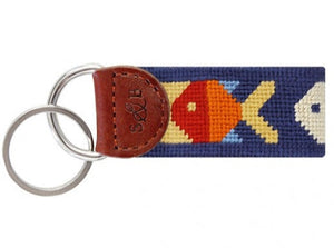 The Smathers & Branson Pompano Key Fob is a pocket-sized needlepoint accessory with leather trim, two metal rings, and a stitched colorful fish design on navy—perfect for adding personality to your keys.