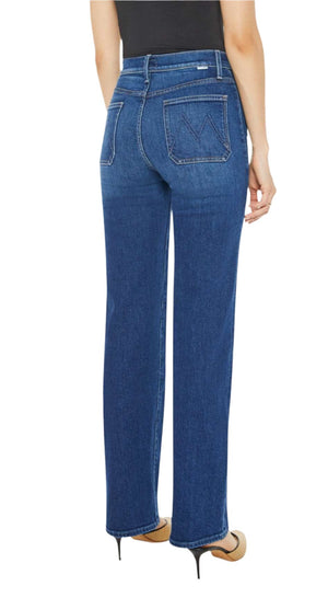 A person wearing Mother Denim Patch Pocket Rambler Zip Sneak jeans with the distinctive M stitch, paired with a black top and tan heels, showcasing a chic outfit.