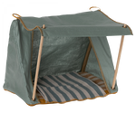 The Maileg Happy Camper Tent is a cozy, small fabric tent with wooden supports and a striped mat inside, perfect for pets or toys. It includes an extra soft blanket and padded bottom for ultimate comfort.