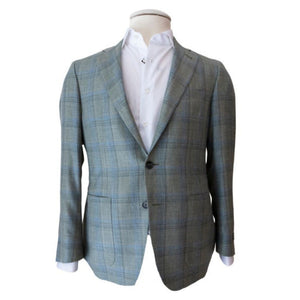 A Canali Moss Blue Plaid Blazer, featuring an exquisite overcheck pattern, is draped over a crisp white dress shirt on a mannequin, showcasing a modern fit against a plain backdrop.