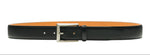 The Rocas Belt by Magnanni is a black leather accessory crafted from tumbled calfskin, with a silver buckle. It’s displayed against a white background and boasts a versatile style suitable for both dressy and casual occasions.