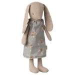 The Maileg Bunny, Size 1 - Classic - Dress features a soft bunny with long floppy ears, embroidered eyes and nose, and a grey floral dress made from natural fabrics, shown standing upright against a plain background.