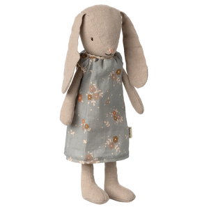 The Maileg Bunny, Size 1 - Classic - Dress features a soft bunny with long floppy ears, embroidered eyes and nose, and a grey floral dress made from natural fabrics, shown standing upright against a plain background.