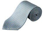 The Eton Geometric Print Silk Tie features a blue silk base with yellow and white geometric patterns, ideal for classic suiting. Shown rolled up on a white background.