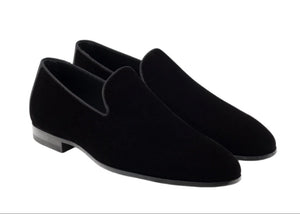 The Jareth Slipper by Magnanni is a pair of black velvet slipper loafers with low heels, seen from an angle, ideal for formal occasions.
