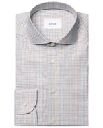 The Eton Slim Cut Away Micro Check Twill Shirt is a long-sleeve, button-up dress shirt in light blue and beige micro check, made from organic cotton.