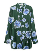 The Dorothee Schumacher Big Garden Blouse is a relaxed-fit silk twill top, boasting a green button-up design adorned with a charming blue and white floral print.