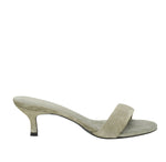 The Suede Sensation Kitten Heel by Dorothee Schumacher is showcased on a white background, featuring a light gray suede slide with an open toe and a contour kitten heel.
