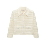The Precise Pointelle Jacket by Dorothee Schumacher is cream-colored, long-sleeve, and cropped with a graphic pointelle design, collar, front buttons, and two front pockets, shown on a white background.