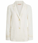 The Grace Palm Embroidered Blazer by Emporio Sirenuse is a white, single-breasted jacket with long sleeves, a two-button front, two front pockets, and delicate embroidery on the sleeves and pockets. Its elegant oversized fit adds effortless style to any outfit.