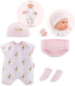 The Corolle Layette Set includes a pink and white striped onesie with gold flamingos, a matching hat, pink diaper cover, socks, pacifier, and clip. Doll shown in inset images.