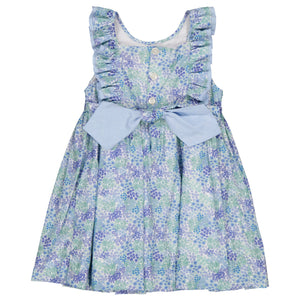 The Kidiwi Baby Girls' and Girls' Mélina Smocked Dress is a sleeveless summer piece made from 100% cotton, showcasing a blue floral pattern, white buttons, ruffled shoulder straps, and a large bow at the waist—perfect for versatile style.