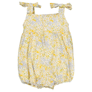 Enjoy the Kidiwi Baby Girls' Francine Smocked Romper, showcasing a yellow floral print with adorable shoulder tie straps and a hand-smocked neckline.