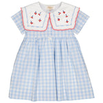Explore the Girls' Paolina Embroidered Dress by Kidiwi: a charming light blue and white checkered short-sleeved dress with a crisp white collar, embroidered cherries, decorative buttons, and red trim.