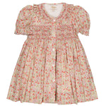 The Kidiwi Baby Girls' Adeline Smocked Dress showcases a floral-patterned, short-sleeved design with a ruffled collar and bodice smocking in pink and green hues, accented by a delicate blue flower print.