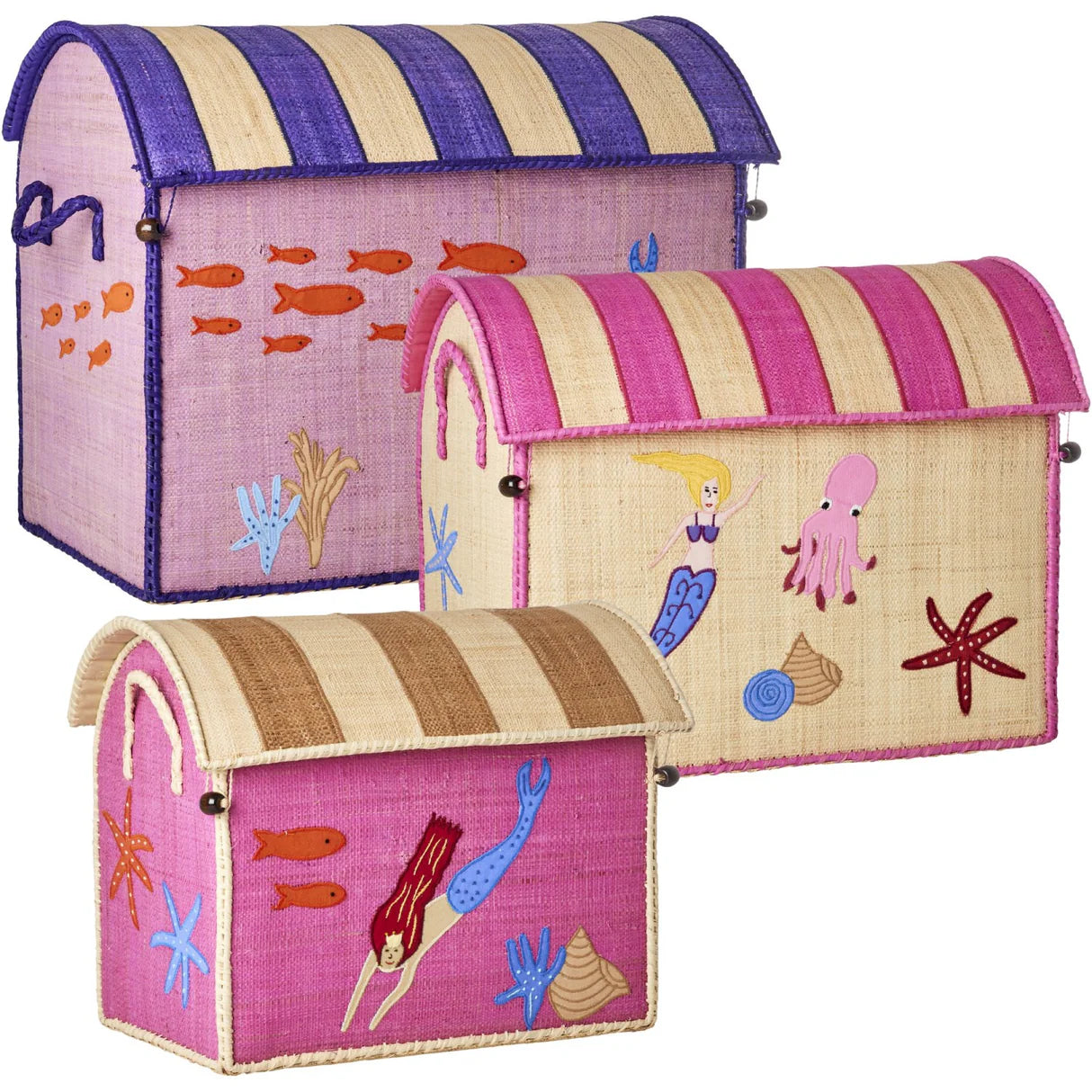 A set of three handmade Raffia Toy Baskets by Rice, crafted from Madagascar raffia, features mermaid and sea-themed designs with striped lids in purple, pink, and beige. These artisanal pieces add a unique touch to your space.