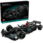 The LEGO® Mercedes-AMG F1 W14 E Performance model is fully built and displayed before its box, showcasing black and teal accents with authentic sponsor logos.