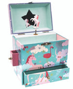 The Floss and Rock Rainbow Woodland Jewelry Box features unicorn and flamingo designs, whimsical illustrations, side and bottom drawers, a star-shaped mirror, and a spinning unicorn figurine inside.