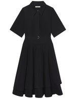 The CO Short Sleeve Belted Dress is a black cotton poplin shirt dress with a collared neckline, button front, belted waist, and tiered chic midi skirt.