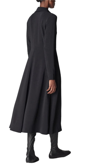 Someone in a stylish black Long Sleeve Crepe Shirt Dress from CO, paired with matching black boots, facing away.