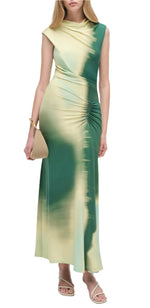 A woman wears the Simkhai Acacia Jersey Midi Dress with a green and beige gradient, featuring an exquisite drape and gathered waist, styled with a tan handbag and beige sandals.