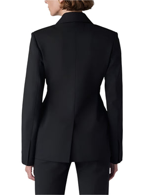 A person confidently stands against a plain white background, wearing CO's Double Breasted Fitted Blazer with matching pants, viewed from behind.