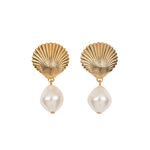 Jennifer Behr's Alana Earrings showcase golden scallop shells with dangling baroque pearls, elegantly presented on a plain white background.