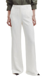 Someone wearing TWP's Howard Coated Viscose Linen Pant in white and a green long-sleeve shirt.
