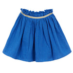 The Girls' Fotini Skirt by Arsene & Les Pipelettes is a blue, knee-length piece with a ruffled waistband, thin gold trim at the top, and a charming flare shape.