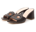 The Laguna Heel by Rupert Sanderson is a black open-toe mule with cutout upper detailing and a block heel, handmade in Italy.
