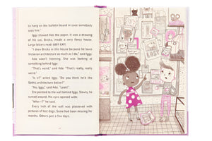 An illustrated page from "Ada Twist and the Disappearing Dogs: (The Questioneers) Book" by Abrams shows two kids in a room with posters, drawings, and missing dog signs. One child points at the wall while the other watches. Text appears on the left page.