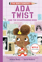A curly-haired girl gazes upward, missing animal posters behind her. She holds "Ada Twist and the Disappearing Dogs: (The Questioneers) Book" by Abrams.