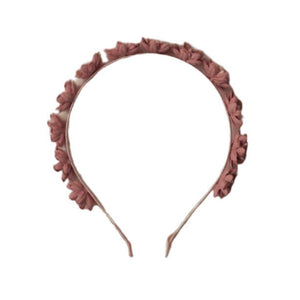 The Noralee Floral Headband features pink fabric flowers evenly spaced along the top, making it a charming statement accessory for any occasion.