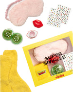 The Beauty Sleep Self Care Kit by Super Smalls includes a plush pink sleep mask, yellow socks, lip balm, green glitter jars, stickers, and a yellow gift box to elevate your bedtime routine.