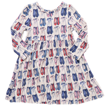 The Girls' Bamboo Steph Dress by Pink Chicken features long sleeves, a gathered waist, and a playful print of pink, red, and blue ballet shoes on soft white bamboo fabric.