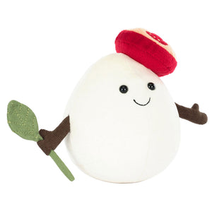 The Jellycat Amuseables Mozzarella is a plush toy shaped like a white egg with brown arms, a green leaf, and a red-and-white mushroom cap—an adorable cheese gift for foodies, complete with black eyes and a smiling face.