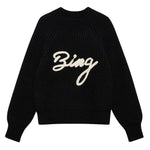 The Kendrick Sweater Bing by Anine Bing is a black alpaca-wool sweater with long sleeves and "Bing" in bold white script across the front, offering cozy style with signature AB branding.