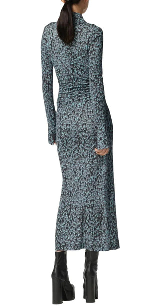 A person wearing an Altuzarra Claudia Dress with ruched detail and black platform boots is facing away from the camera.