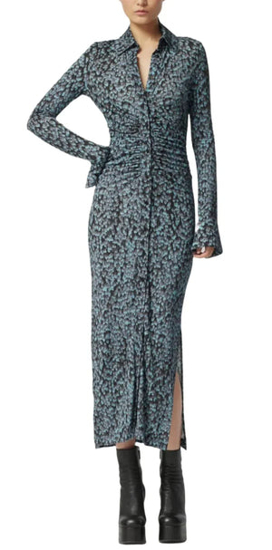 The Claudia Dress by Altuzarra, a long-sleeved patterned jersey with a graceful slit and ruched details, is perfected with black platform boots, turning it into an elegant statement.