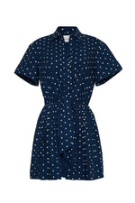 The Cara Cara Asbury Dots Mini Dress features white polka dots on navy, a collared neckline, button front, and self-tie waist sash—an effortlessly stylish sell-out favorite.