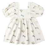 The Baby Girls' and Girls' Brea Dress by Rylee & Cru is a cream, short-sleeved dress with a square neckline, empire waist, gathered skirt, and small multicolored bow pattern.