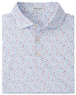 A neatly folded Peter Millar Orange Crush Performance Jersey Polo featuring a collared design, vibrant orange color, UPF 50+ sun protection, four-way stretch fabric, and a three-button placket.