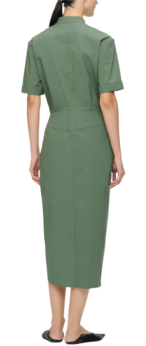 A person is wearing the Bali Dress by Callas Milano, a knee-length military green shirt dress made from Italian cotton poplin with short sleeves, viewed from the back.