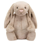 The Jellycat Bashful Beige Bunny, Giant, featuring soft fur, floppy ears, and a pink nose, sits upright against a white background. This plush companion is the perfect gift for any occasion.