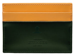 The Bridle Flat Credit Card Case by Ettinger is a two-tone leather accessory in yellow and dark green, made from bridle hide. It includes compartments for cards and embossed text: "Ettinger London" and "ESTD 1934.