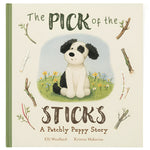 The "JC The Pick of the Sticks Book" by Jellycat features a charming illustration of a black and white Patchly Puppy sitting among sticks and flowers, capturing his heartfelt quest for the perfect stick.